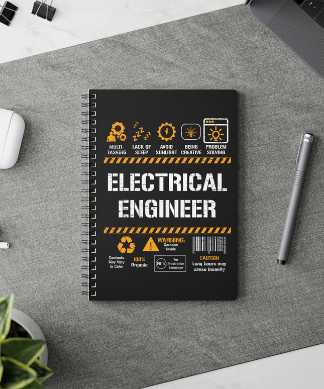 Notebook with 'Electrical Engineer' design on a desk with a pen and earbuds.