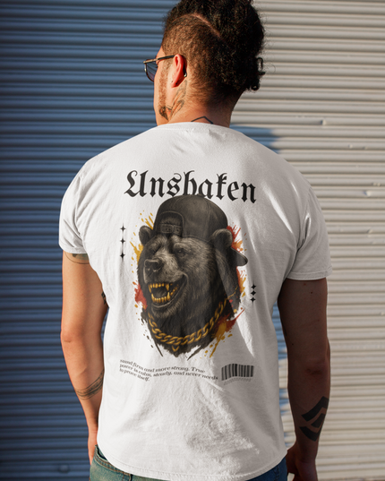 Person wearing a white t-shirt with a bear graphic design on the back, standing in front of a metallic shutter.
