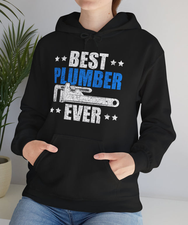 Person wearing a black hoodie with 'Best Plumber Ever' text and graphic, standing indoors.