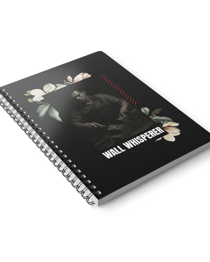 Notebook with floral design and 'Wall Whisperer' text on a white background