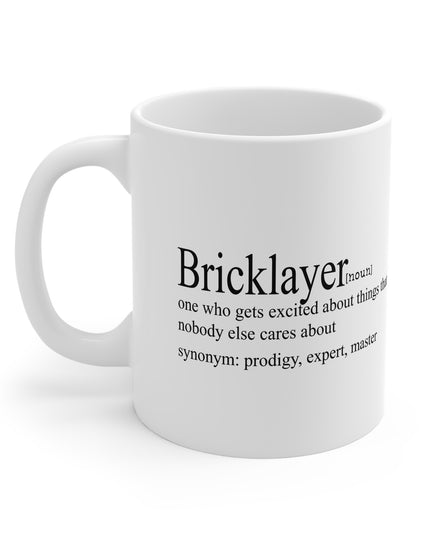 White mug with black text definition of a 'Bricklayer' on a white background
