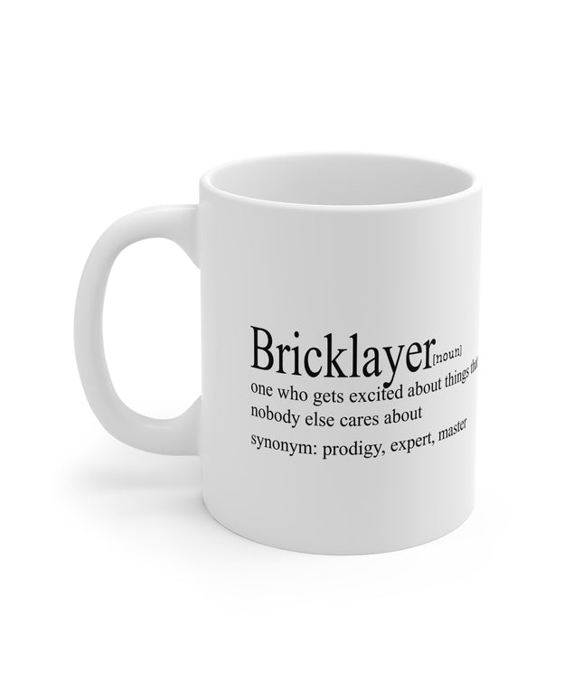 White mug with black text definition of a 'Bricklayer' on a white background
