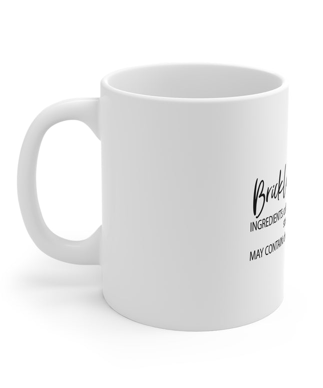 White mug with black text on a white background