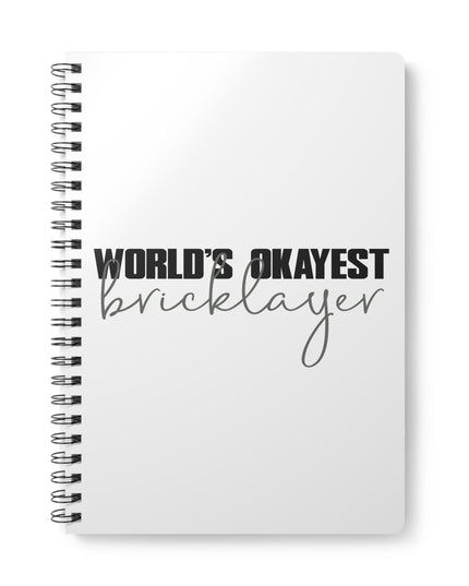 Notebook with 'World's Okayest Bricklayer' text on a white background
