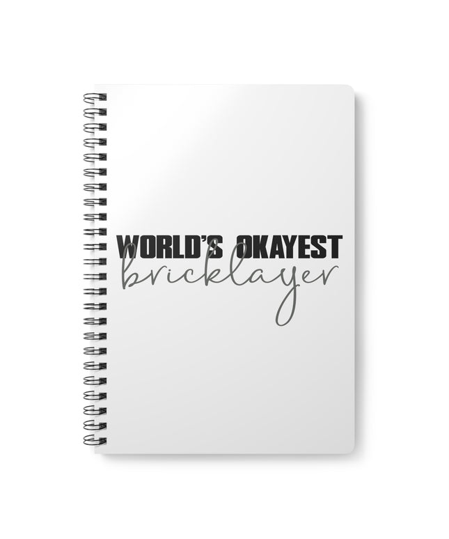 Notebook with 'World's Okayest Bricklayer' text on a white background
