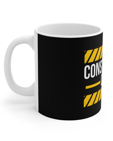 Mug with black background and yellow and white text on a white background