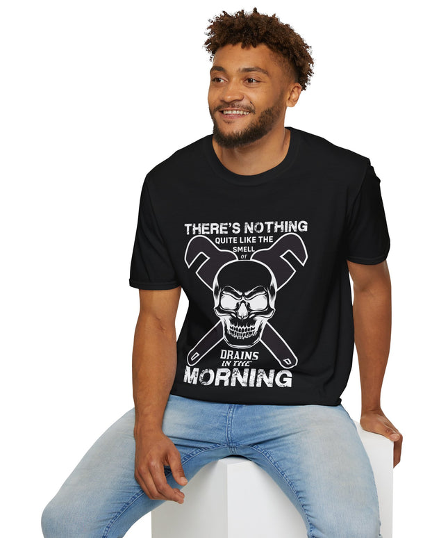 Man leaning on a chair and wearing a black t-shirt with a skull graphic and text "There's nothing quite like the smell of drains in the morning", on a white background