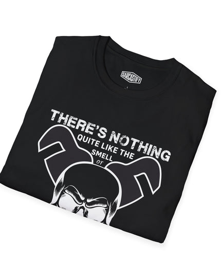 Folded black t-shirt with a skull graphic and text "There's nothing quite like the smell of drains in the morning", on a white background