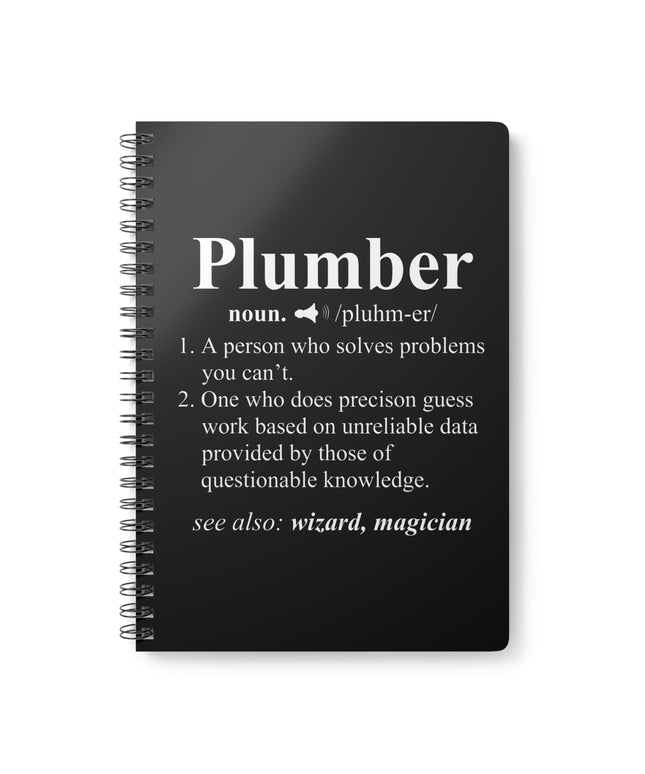Black notebook with white text definition of 'plumber' on a white background