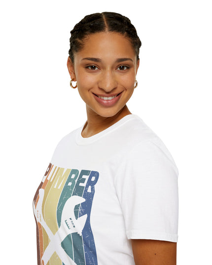 Woman wearing white t-shirt with plumber tools, text, and a rainbow graphic on a white background